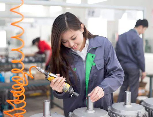 young chinese woman works in motor manufacturing factory